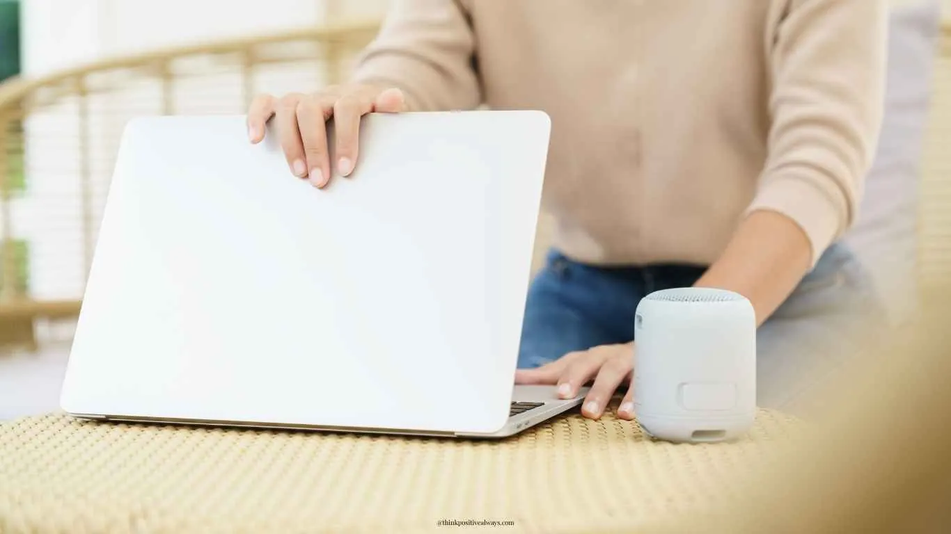 A professional closing a laptop to create work-life balance.