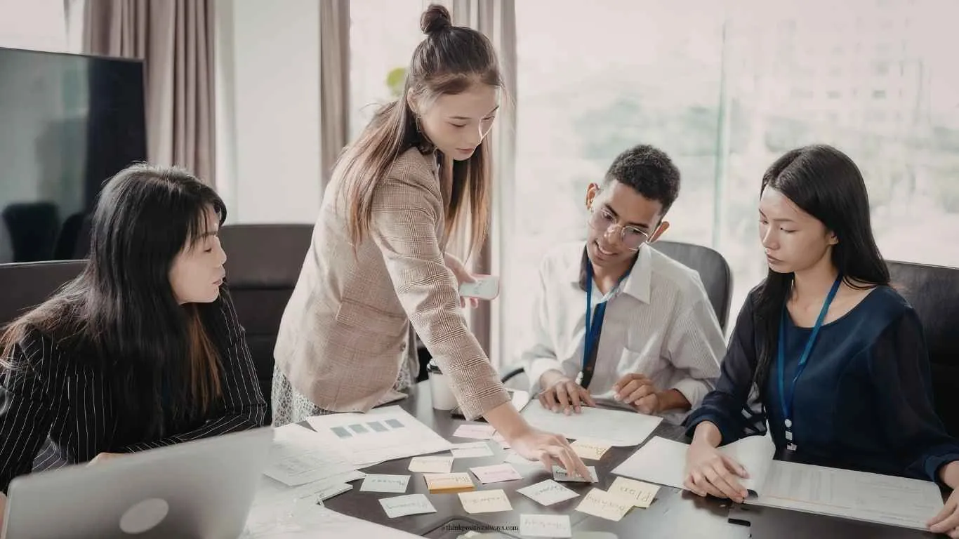 A diverse team brainstorming together around a table in a modern office.